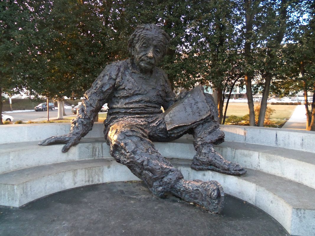 Statue of Albert Einstein reading a book